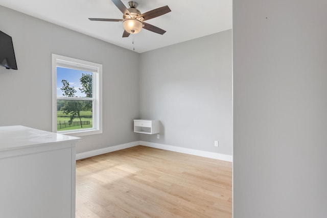 spare room with ceiling fan and light hardwood / wood-style floors