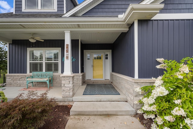 view of exterior entry with a porch and ceiling fan