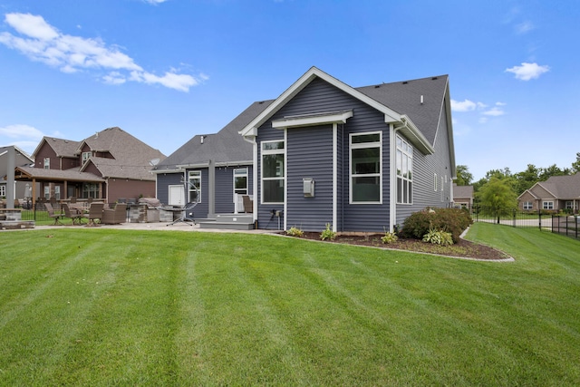 back of property featuring a patio area and a yard