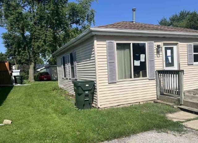 view of side of home featuring a lawn