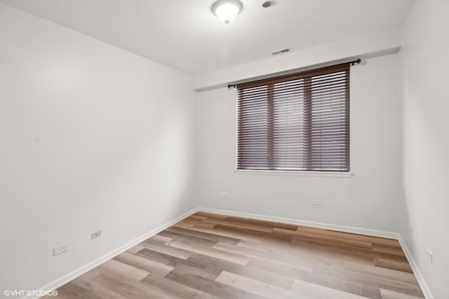 empty room with light hardwood / wood-style floors