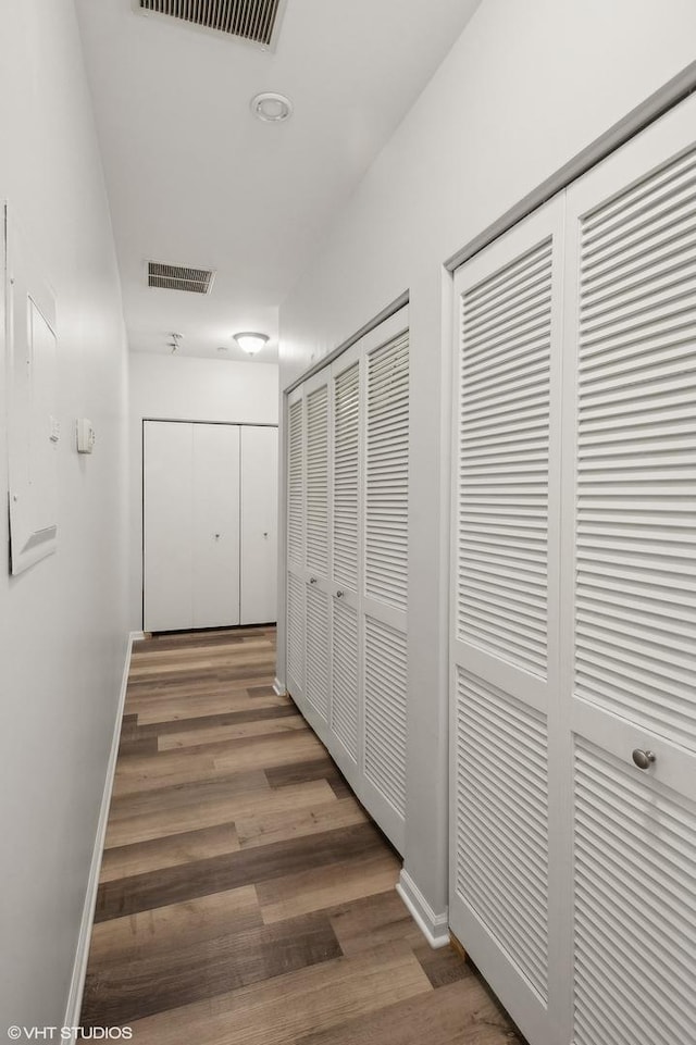 corridor featuring dark hardwood / wood-style floors