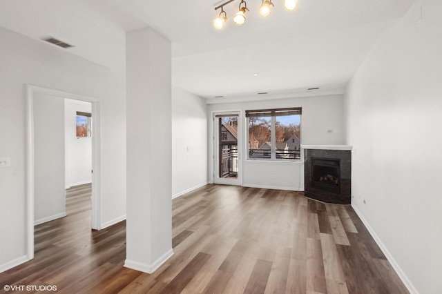 unfurnished living room with wood-type flooring