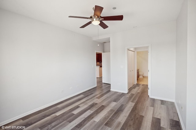 empty room featuring ceiling fan and light hardwood / wood-style floors