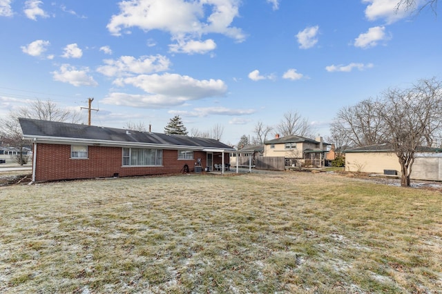 back of house with a lawn and a sunroom