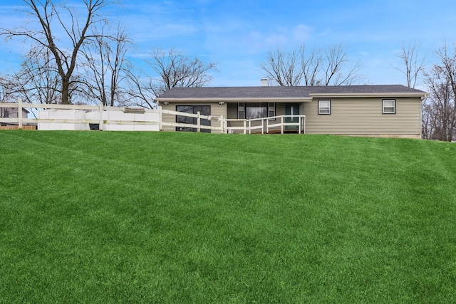 rear view of property with a lawn