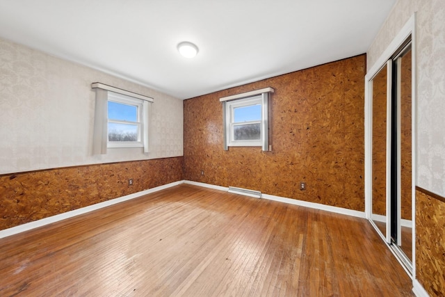 unfurnished room with wood-type flooring