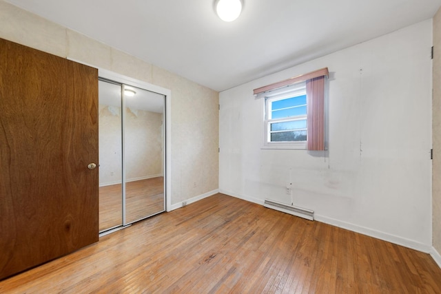 unfurnished bedroom with light hardwood / wood-style floors and a closet