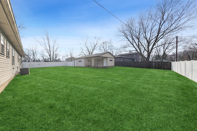 view of yard with cooling unit and an outbuilding