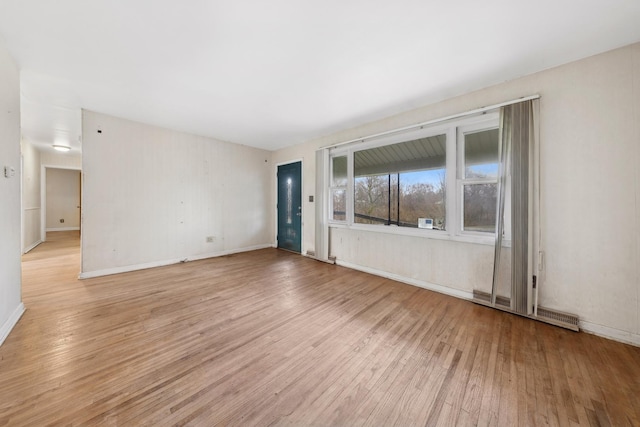 spare room featuring light hardwood / wood-style floors