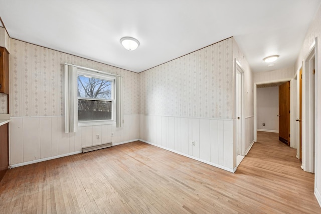 interior space with baseboard heating and light hardwood / wood-style flooring