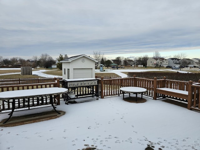 snow covered deck featuring a grill