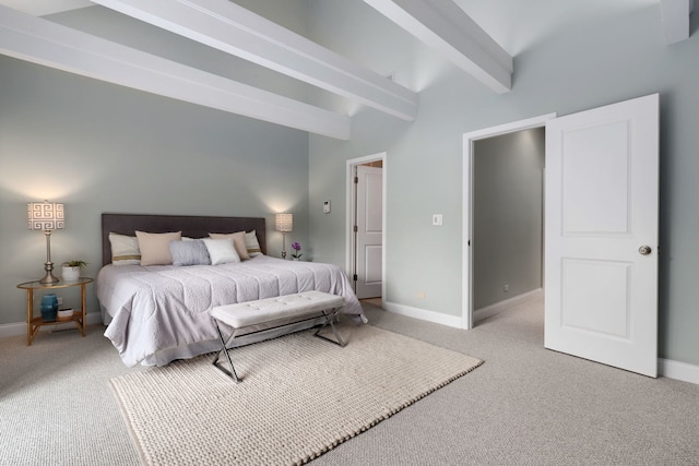 carpeted bedroom with beam ceiling