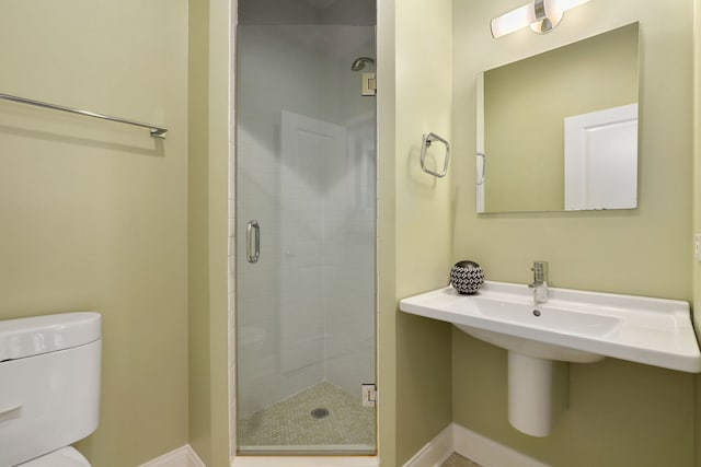 bathroom with toilet and a shower with shower door