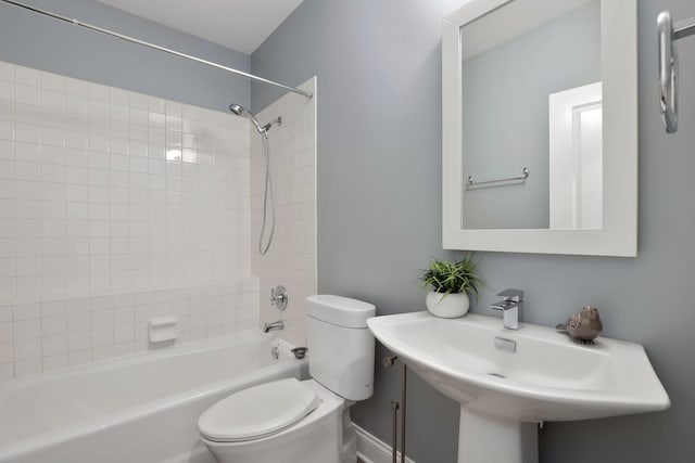 full bathroom with toilet, tiled shower / bath, and sink