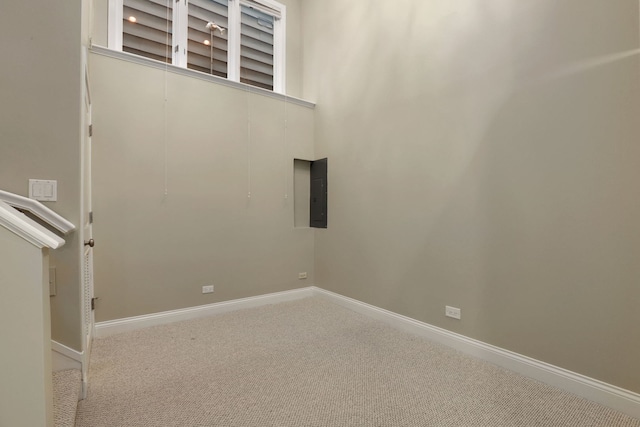 carpeted empty room featuring electric panel