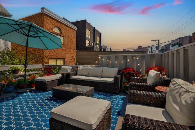 patio terrace at dusk featuring outdoor lounge area