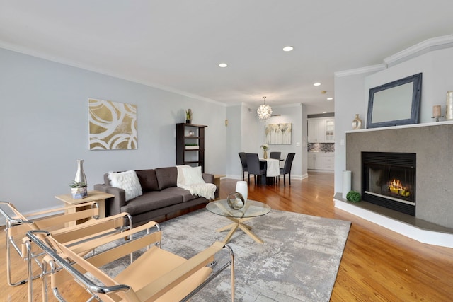 living room with wood-type flooring and ornamental molding