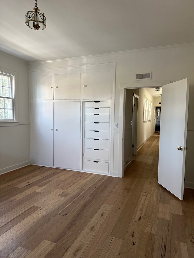 unfurnished bedroom with hardwood / wood-style flooring and a closet