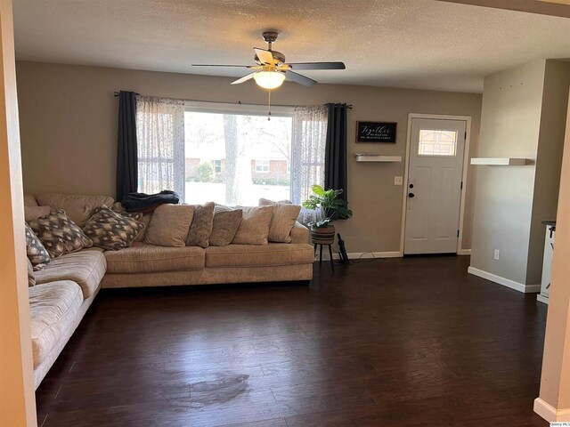 2433 Cedar Creek Ct, Quincy, IL 62305 - unfurnished living room featuring ceiling fan, dark wood-type flooring, and a textured ceiling