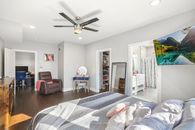 bedroom featuring ensuite bath, ceiling fan, dark hardwood / wood-style floors, a spacious closet, and a closet