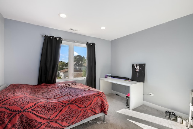 bedroom with light colored carpet