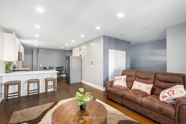 living room featuring dark wood-type flooring