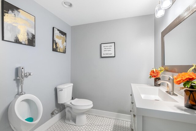 bathroom featuring tile patterned floors, vanity, and toilet