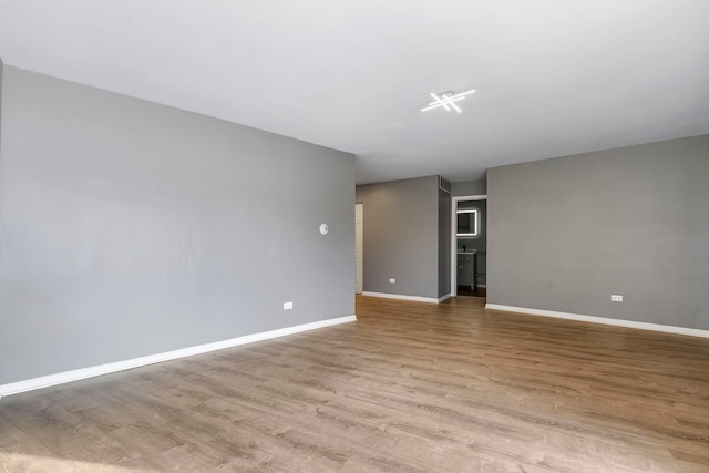 empty room with light hardwood / wood-style flooring