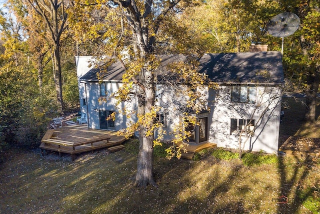 rear view of property featuring a lawn