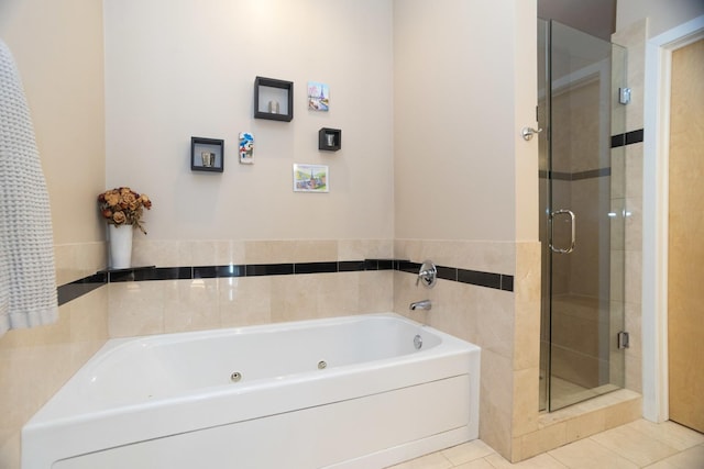 bathroom featuring tile patterned flooring and shower with separate bathtub