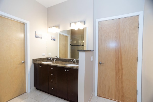 bathroom with tile patterned flooring, vanity, and a shower with shower door