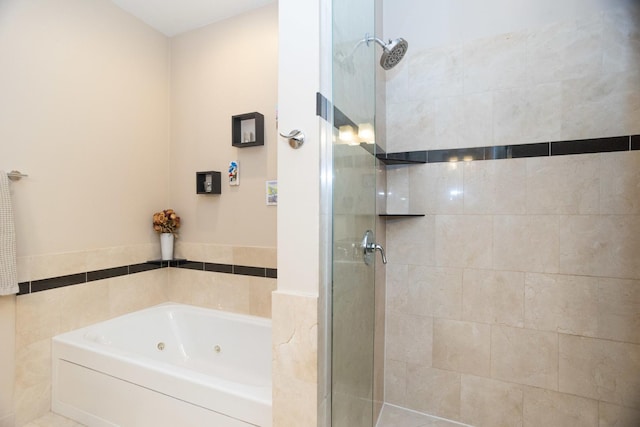 bathroom featuring tile walls and shower with separate bathtub