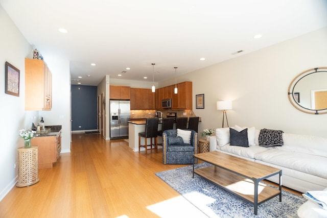 living room with light hardwood / wood-style flooring