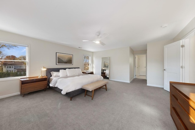 carpeted bedroom with multiple windows and ceiling fan