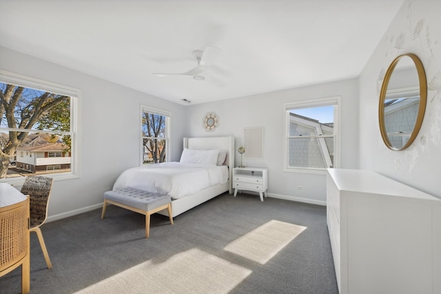 carpeted bedroom featuring multiple windows and ceiling fan