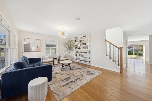 living room with hardwood / wood-style floors and an inviting chandelier