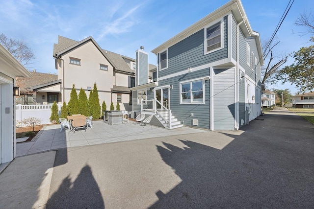 back of property with a patio