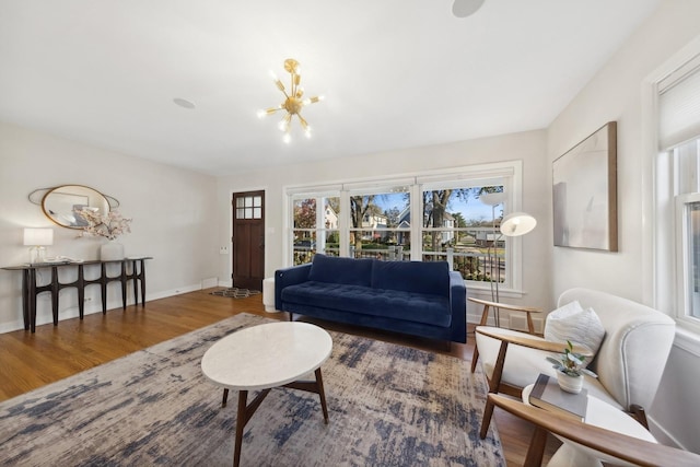 living room with hardwood / wood-style floors and a chandelier