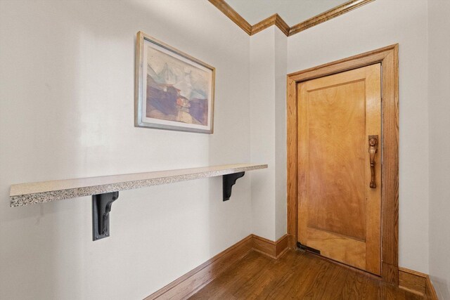 interior space featuring hardwood / wood-style flooring and crown molding