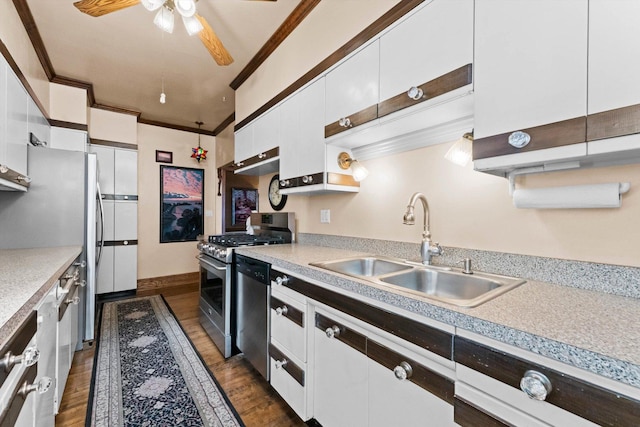 kitchen featuring ornamental molding, stainless steel appliances, ceiling fan, sink, and white cabinetry