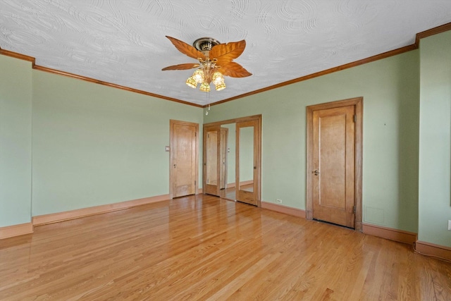 interior space with crown molding, ceiling fan, light hardwood / wood-style floors, and a textured ceiling