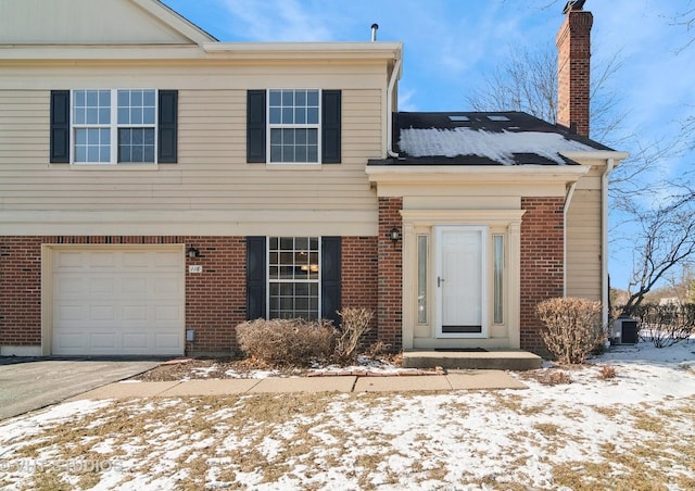 view of front of house featuring central air condition unit and a garage