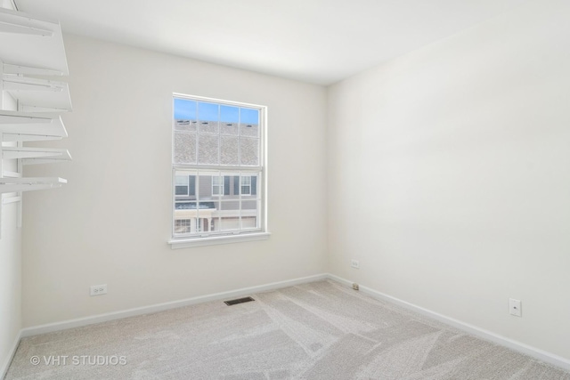 unfurnished room featuring light colored carpet