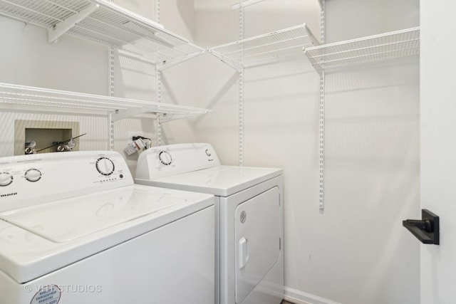 clothes washing area featuring independent washer and dryer