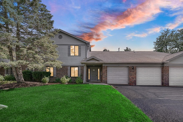 view of front property with a garage and a yard