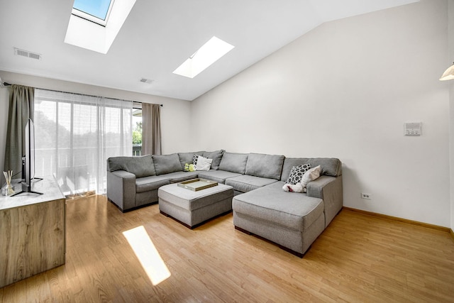 living room with hardwood / wood-style floors and vaulted ceiling