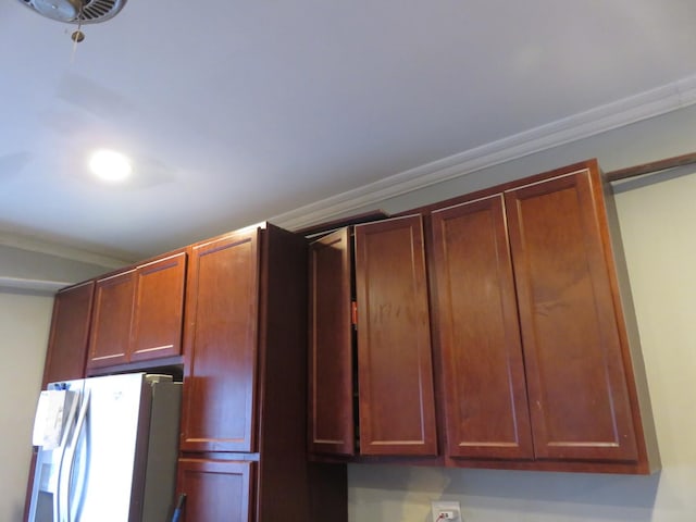 kitchen with white refrigerator with ice dispenser and ornamental molding