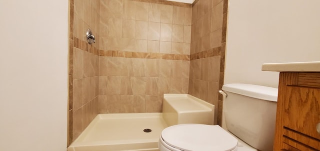 bathroom with toilet and tiled shower