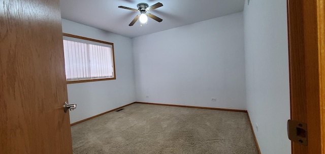 unfurnished room featuring ceiling fan and light carpet